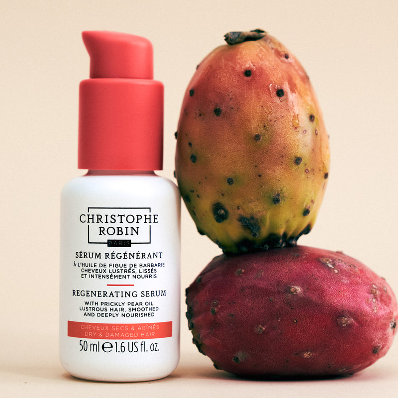 Regenerating serum bottle with a prickly pear fruit on a beige background