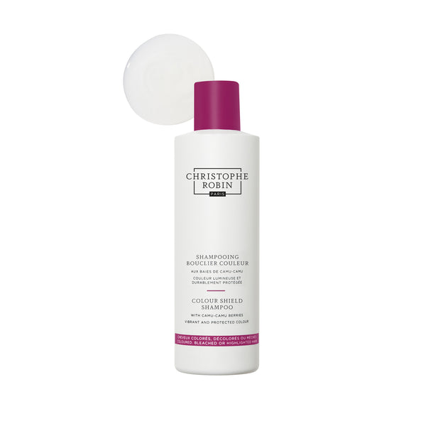 Christophe Robin Colour Shield Shampoo bottle with white label and purple accents on a white background with texture 