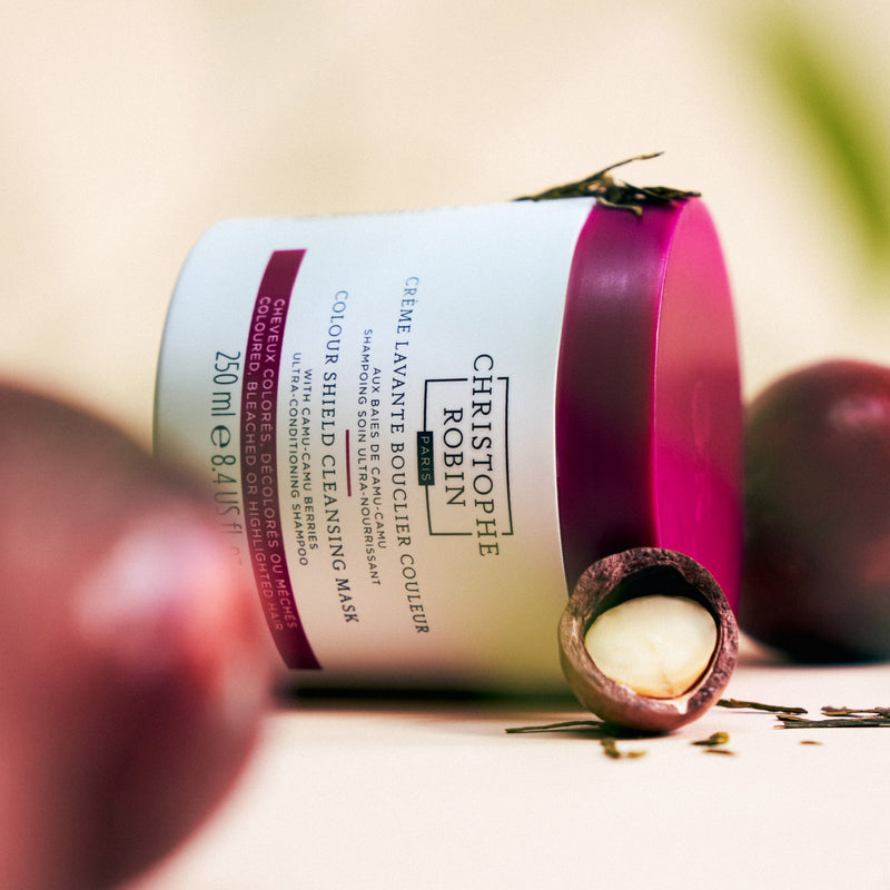 Cleansing mask bottle with a blurred background and ingredients