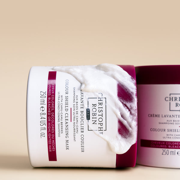Two bottles of Christopher Robin colour shield cleansing mask products on a beige background