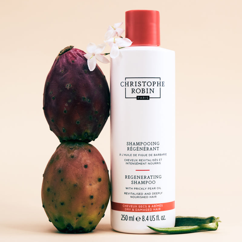 Christophe Robin Regenerating shampoo 250ml with a prickly pear fruit on a beige background