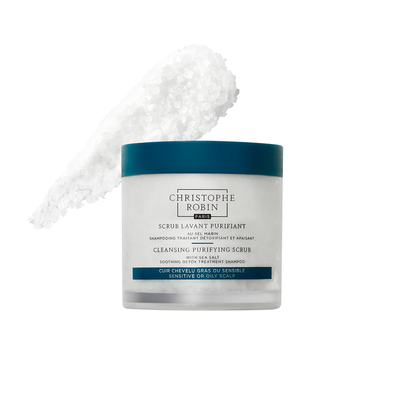 Cleansing purifying scrub container with blue lid showing product texture on a white background