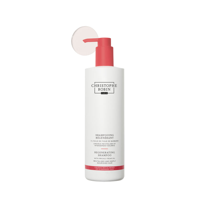 Bottle of Christophe Robin Regenerating shampoo 500ml with red pump on a white background