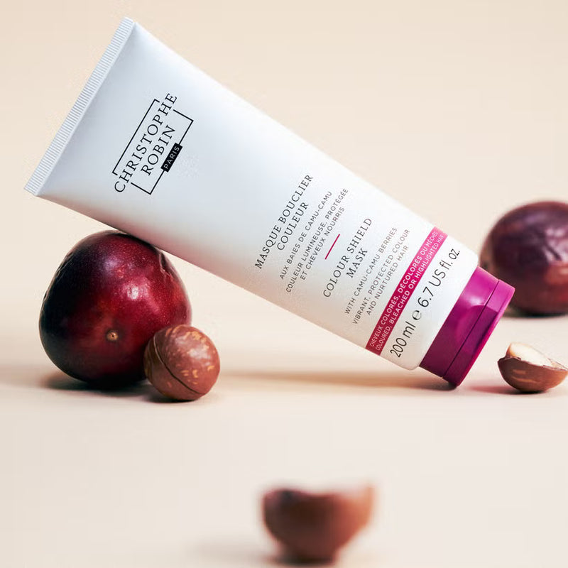Tube of Christophe Robin hair mask with chestnuts on a beige background