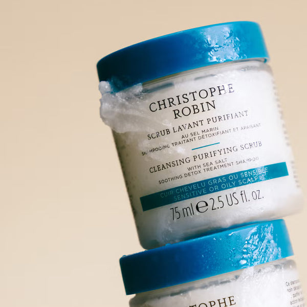 Jar of Christophe Robin cleansing purifying scrub 75ml with blue lid on beige background