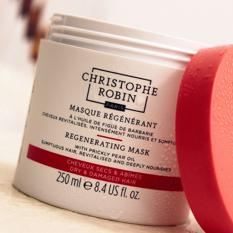 Regenerating hair mask jar with open lid and Christophe Robin branding on a light background