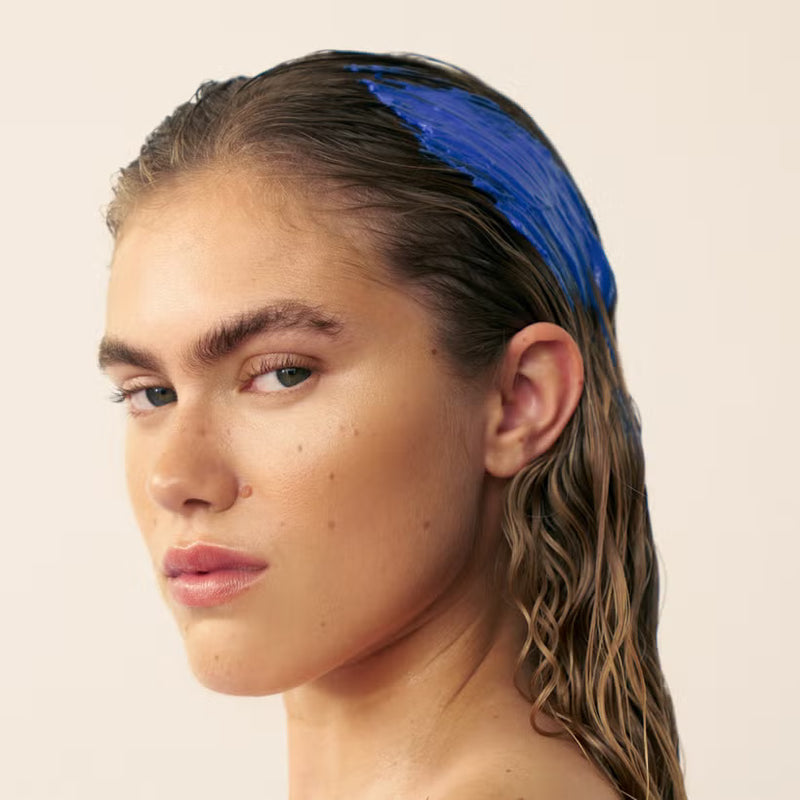 Blonde woman with Christophe Robin Shade variation mask in baby blonde applied on wet hair  