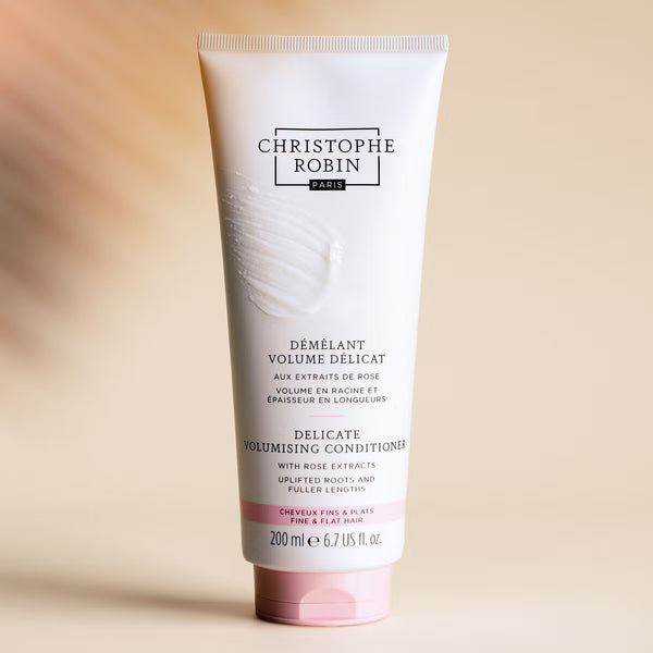 Tube of Christophe Robin Delicate Volumising Conditioner on a beige background