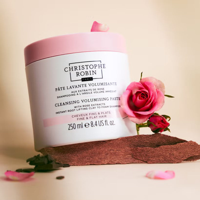 Cleansing Volumising Paste container with a pink lid and rose decorations on a beige background
