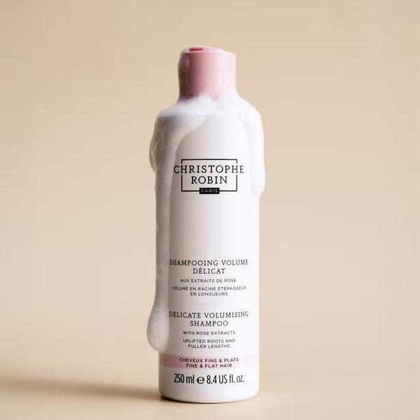 Christophe Robin Delicate volumising shampoo bottle on a beige background